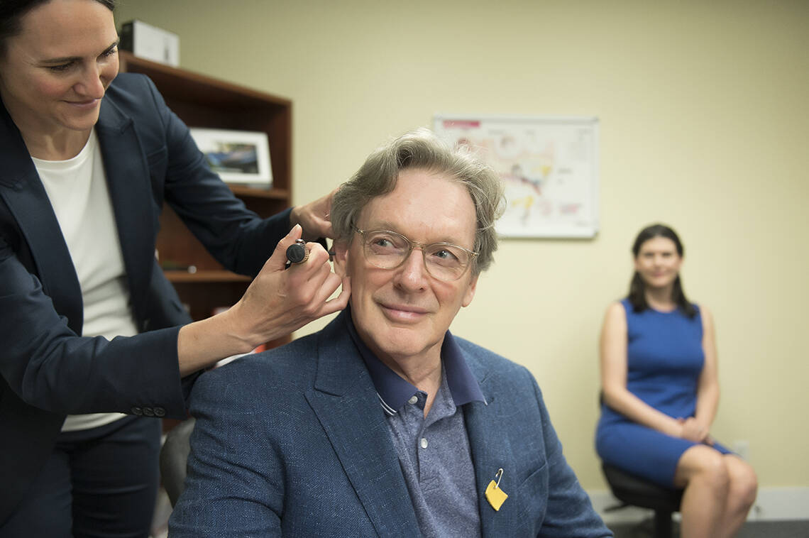 Shelagh Merrill, co-owner of Nanaimo Hearing Clinic, helps a client. © 2022 HA Photography