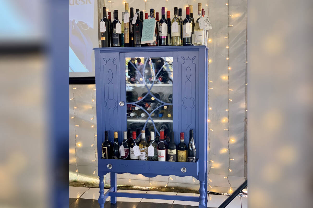 The ‘Wine Wall’ for the Chilliwack Hospice Society’s annual fundraising gala features a variety of wines and a beautiful cabinet to store them.