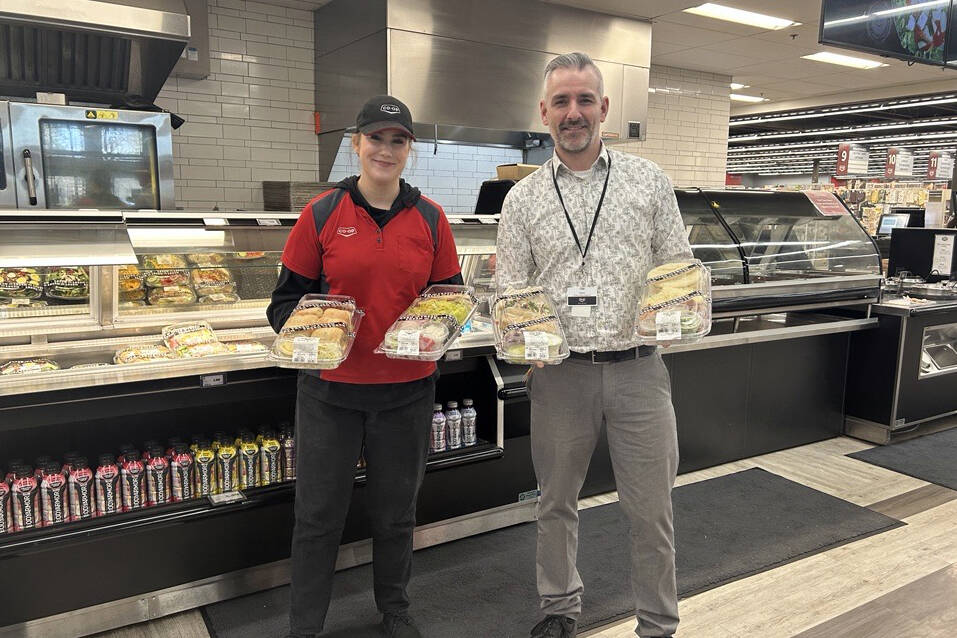 Glen Chisholm (right) and another Otter Co-op team member, show off some of the delicious and easy meal solutions available from the Otter Co-op Deli.